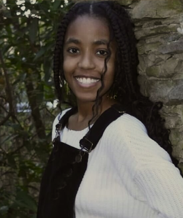 trubel&co Mapping Justice alumna smiling, featured for her achievements in STEM and community leadership.